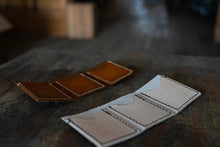 Load image into Gallery viewer, One of our best sellers. Three pocket trifold. Great for cards and folded cash. Full grain leather with waxed polyester thread. 9” by 4” unfolded. 3&quot; by 4&quot; folded. Snowday Leather | Missoula, MT