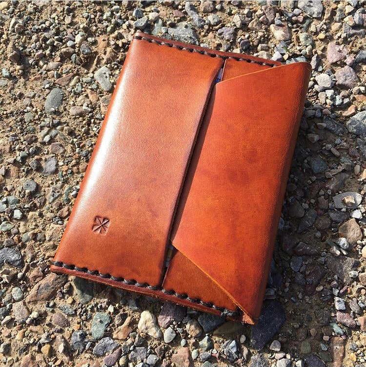 Two card sleeves with tucked flap closure.  Full grain chrome or vegetable tanned leather.  4.5